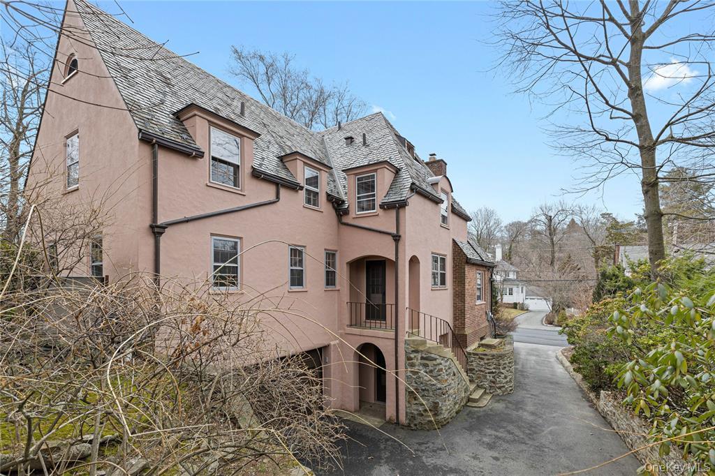 6 Fox Meadow Road Scarsdale, NY 10583 - Photo 17 of 20 View of home's exterior with stairs, a chimney, and stucco siding