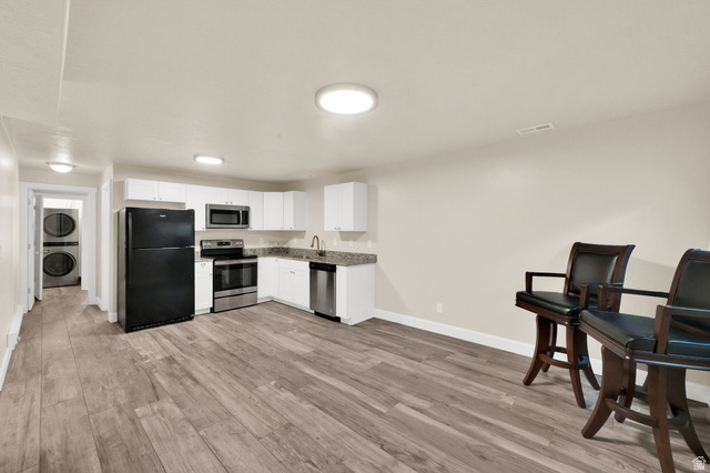 1857 Thunder Gulch Road Eagle Mountain, UT 84005 - Photo 31 of 50 Open-concept living area featuring wood-finish flooring and recessed lighting