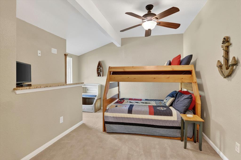 8877 Random Road Fort Worth, TX 76179 - Photo 22 of 40 Vaulted ceiling room featuring a ceiling fan with integrated lighting, textured wall finishes, and carpet flooring