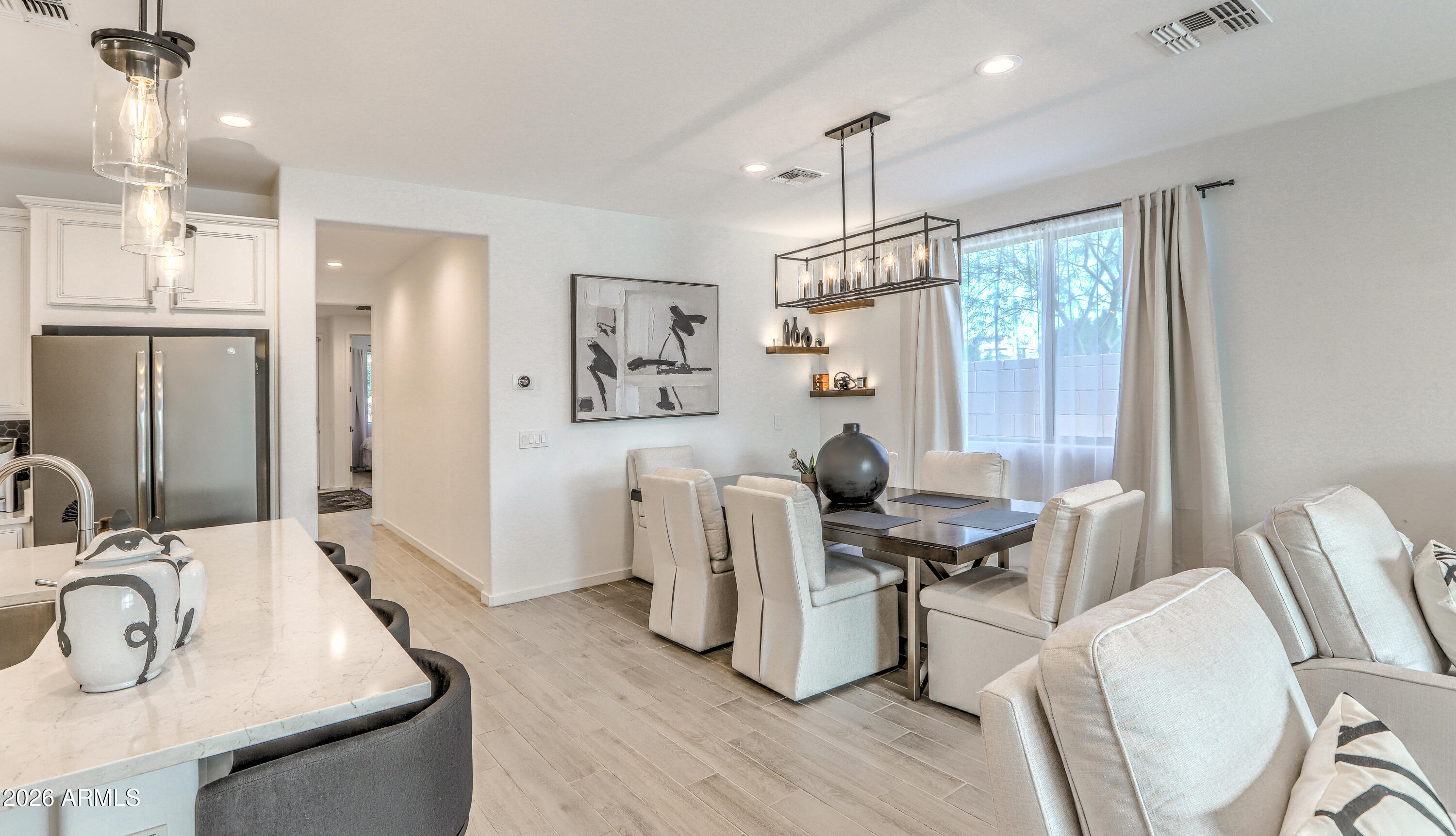 7727 West Agora Lane Phoenix, AZ 85043 - Photo 11 of 46 a view of a dining room with furniture window and wooden floor