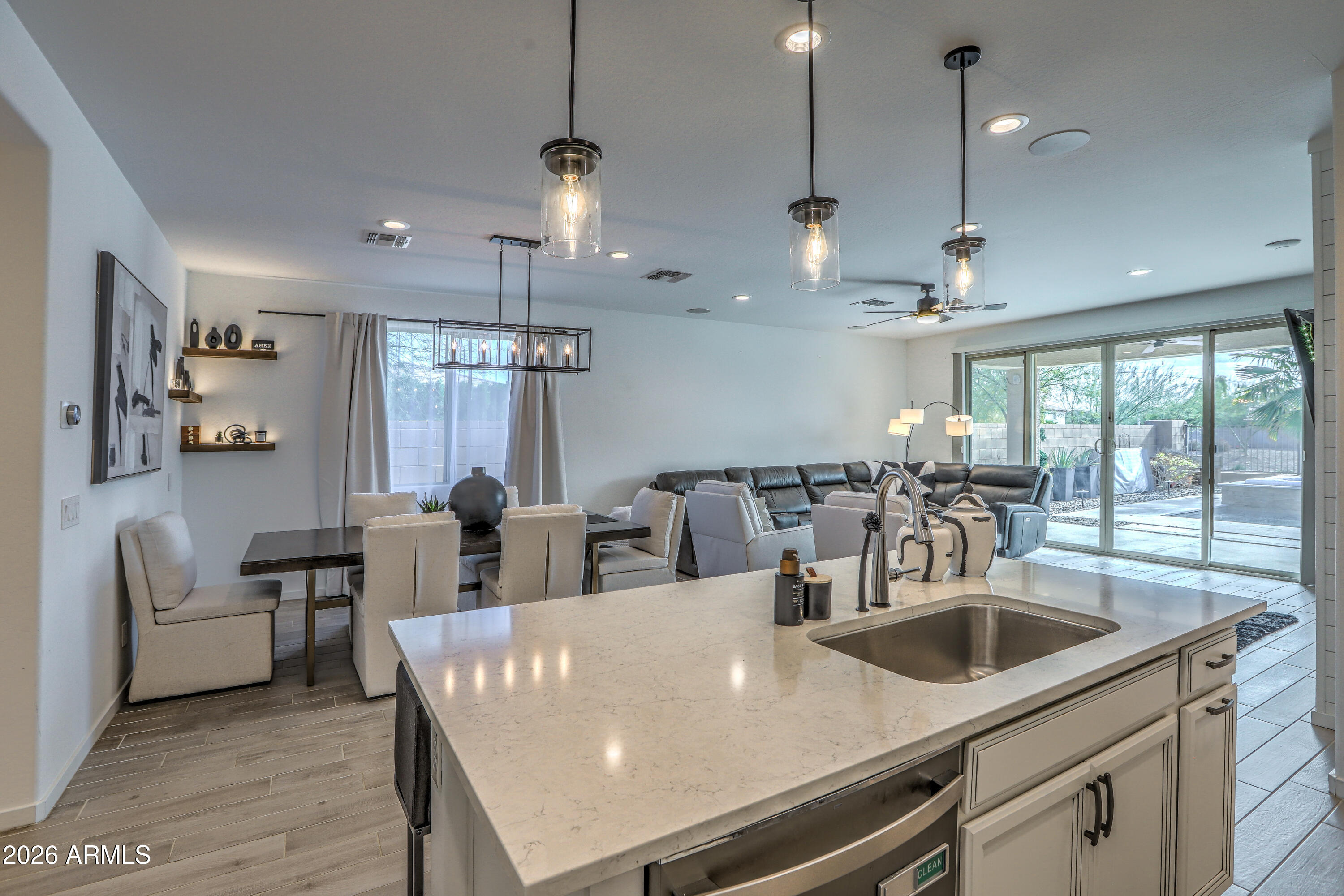 7727 West Agora Lane Phoenix, AZ 85043 - Photo 12 of 46 a view of a dining room and livingroom with furniture wooden floor a chandelier