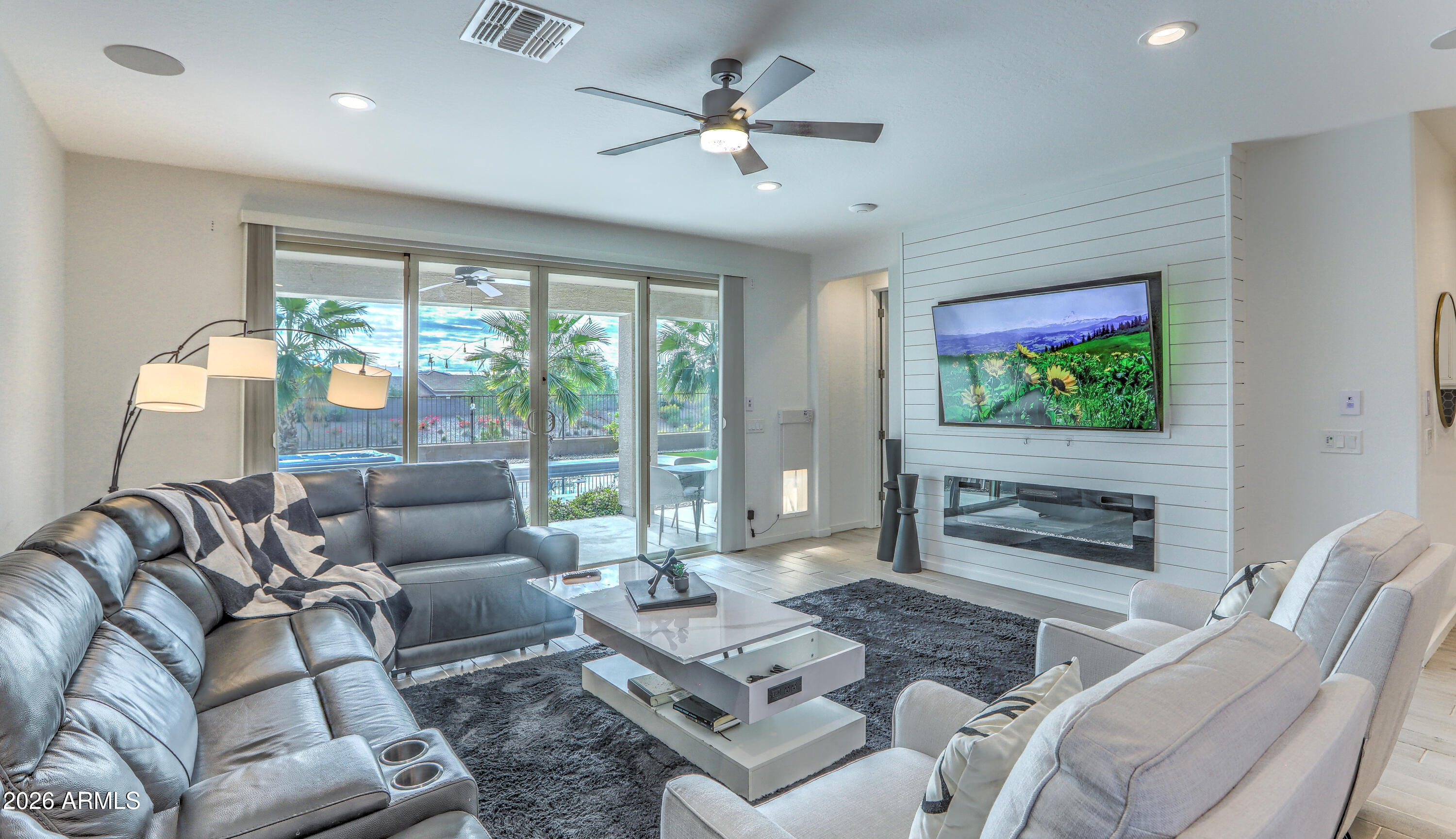 7727 West Agora Lane Phoenix, AZ 85043 - Photo 17 of 46 a living room with furniture ceiling fan and a floor to ceiling window
