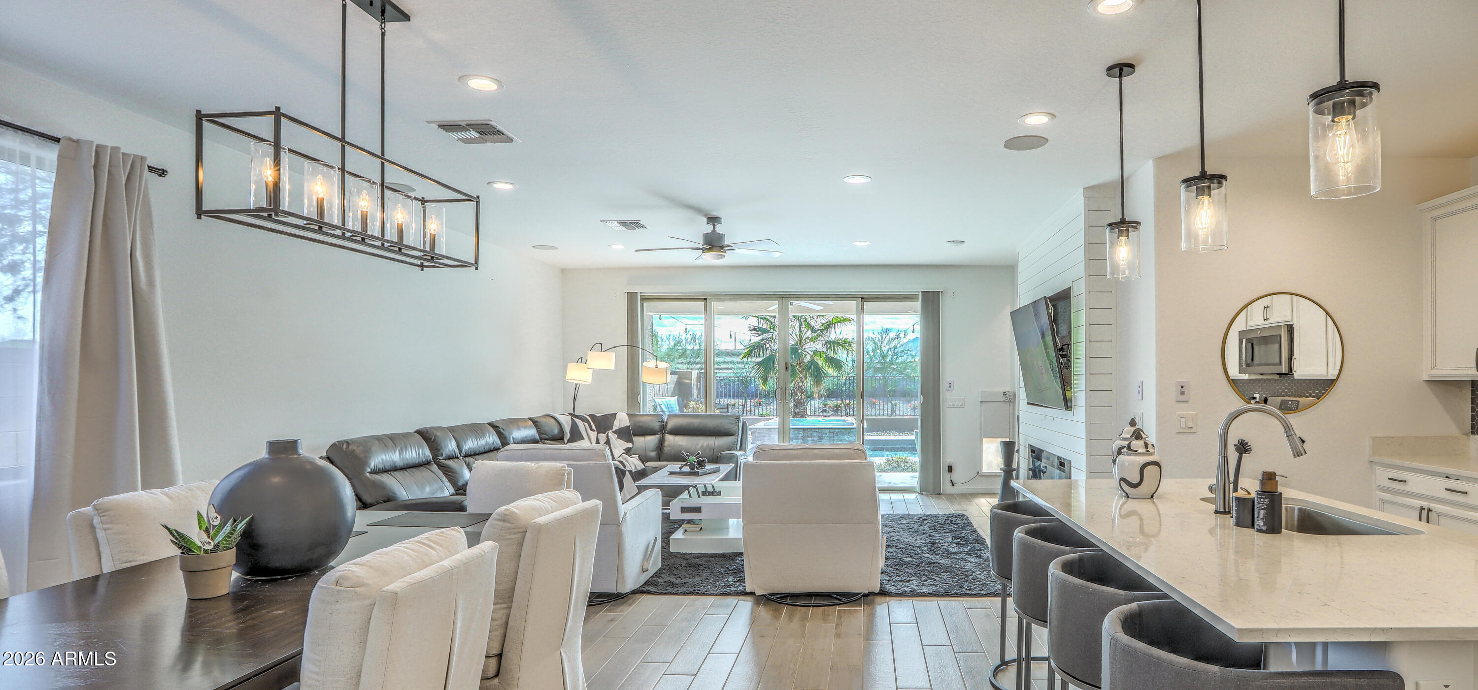 7727 West Agora Lane Phoenix, AZ 85043 - Photo 18 of 46 a view of a dining room with furniture a chandelier and wooden floor