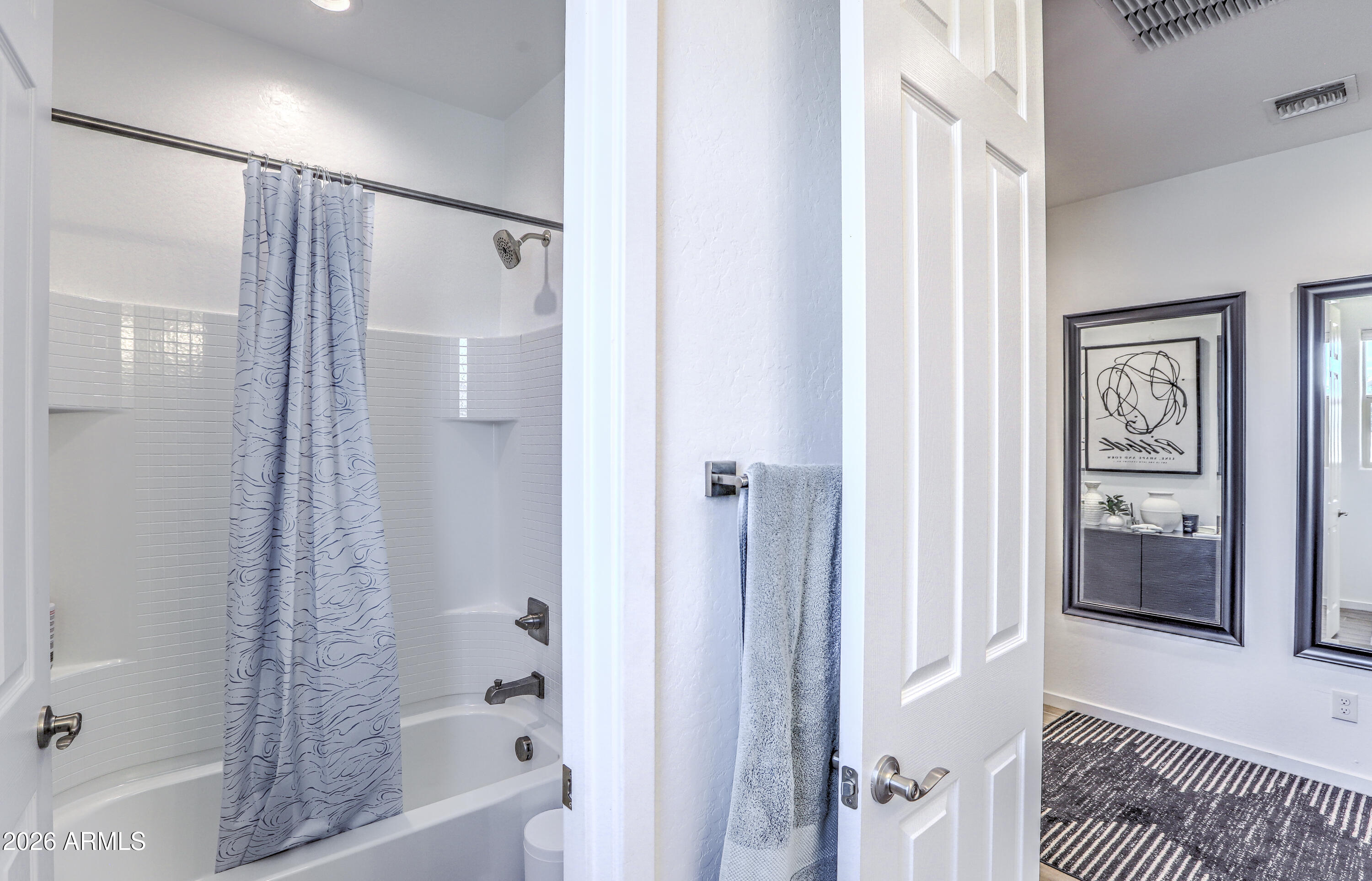 7727 West Agora Lane Phoenix, AZ 85043 - Photo 25 of 46 a bathroom with a bathtub and a shower