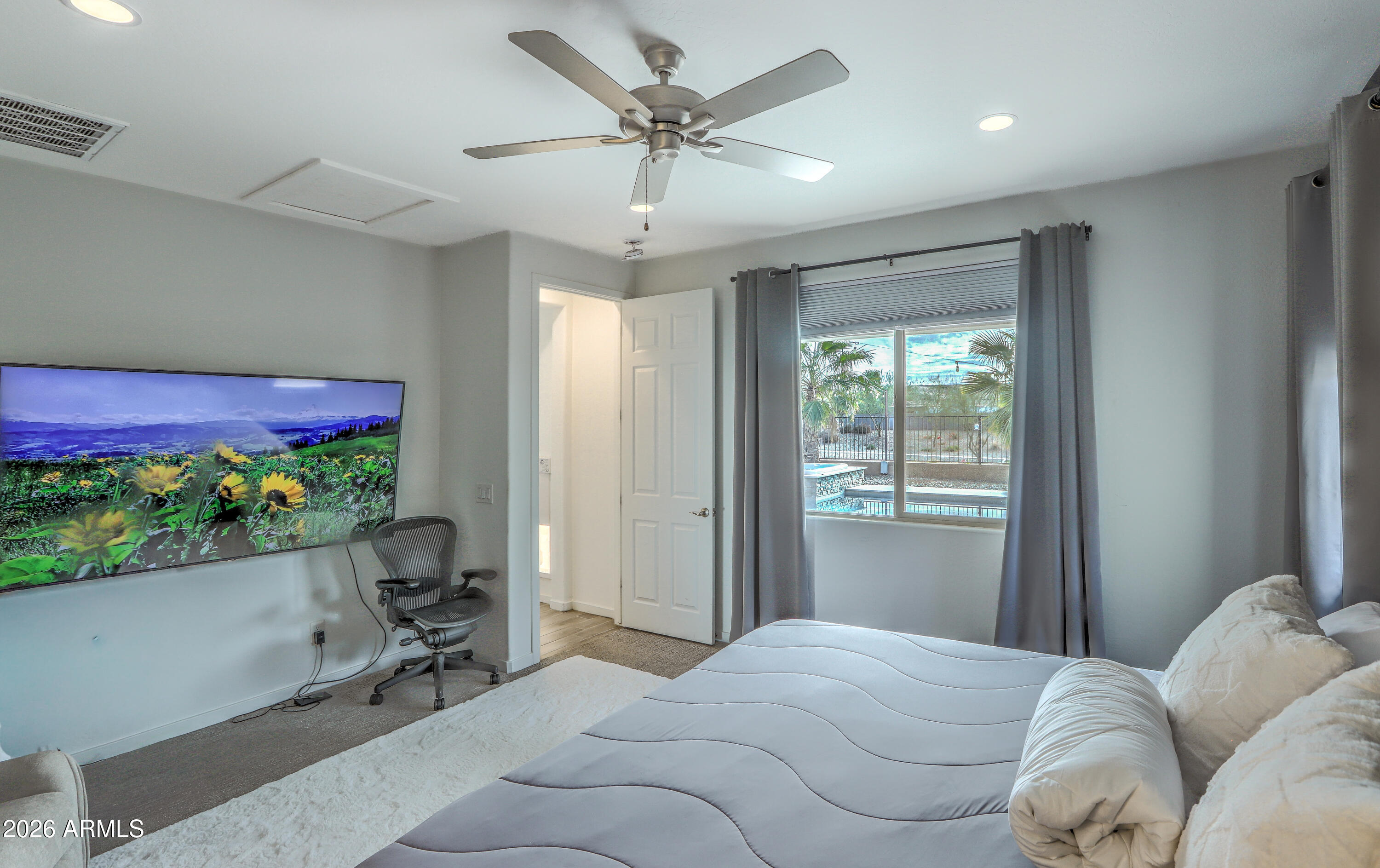 7727 West Agora Lane Phoenix, AZ 85043 - Photo 27 of 46 a bed room with a bed and a chair