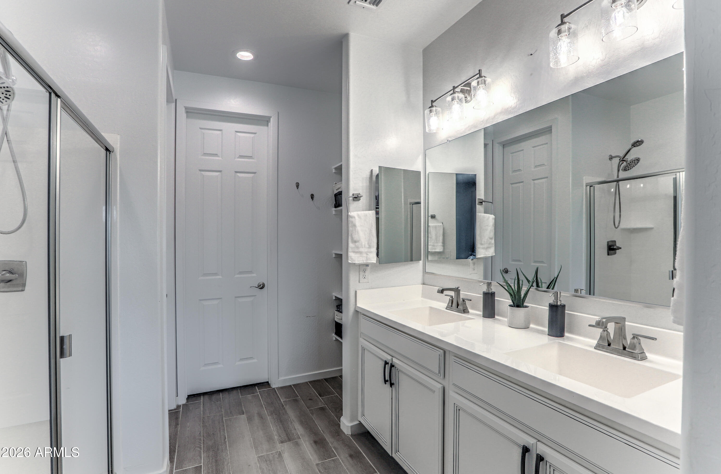 7727 West Agora Lane Phoenix, AZ 85043 - Photo 28 of 46 a bathroom with a double vanity sink mirror and shower