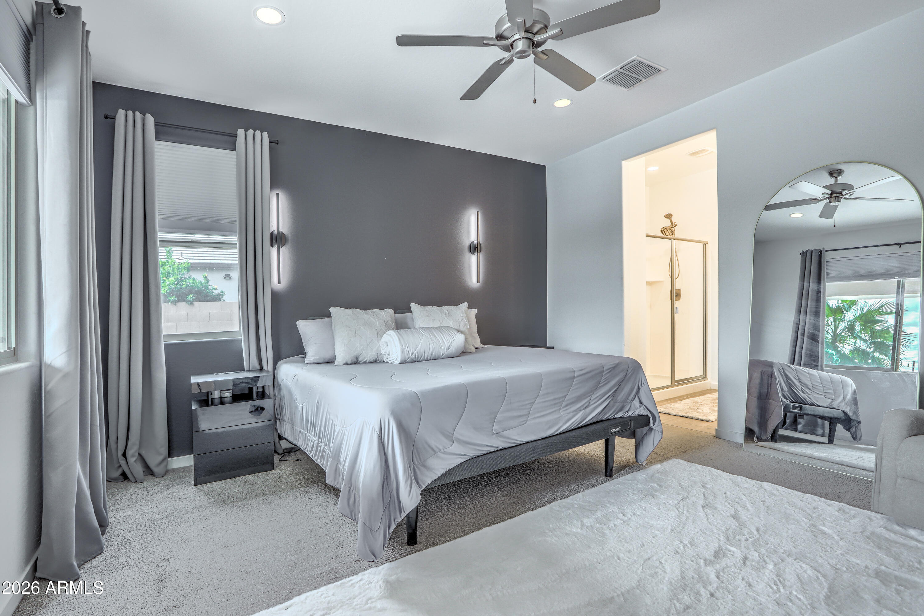 7727 West Agora Lane Phoenix, AZ 85043 - Photo 29 of 46 a bedroom with a large bed and a chandelier