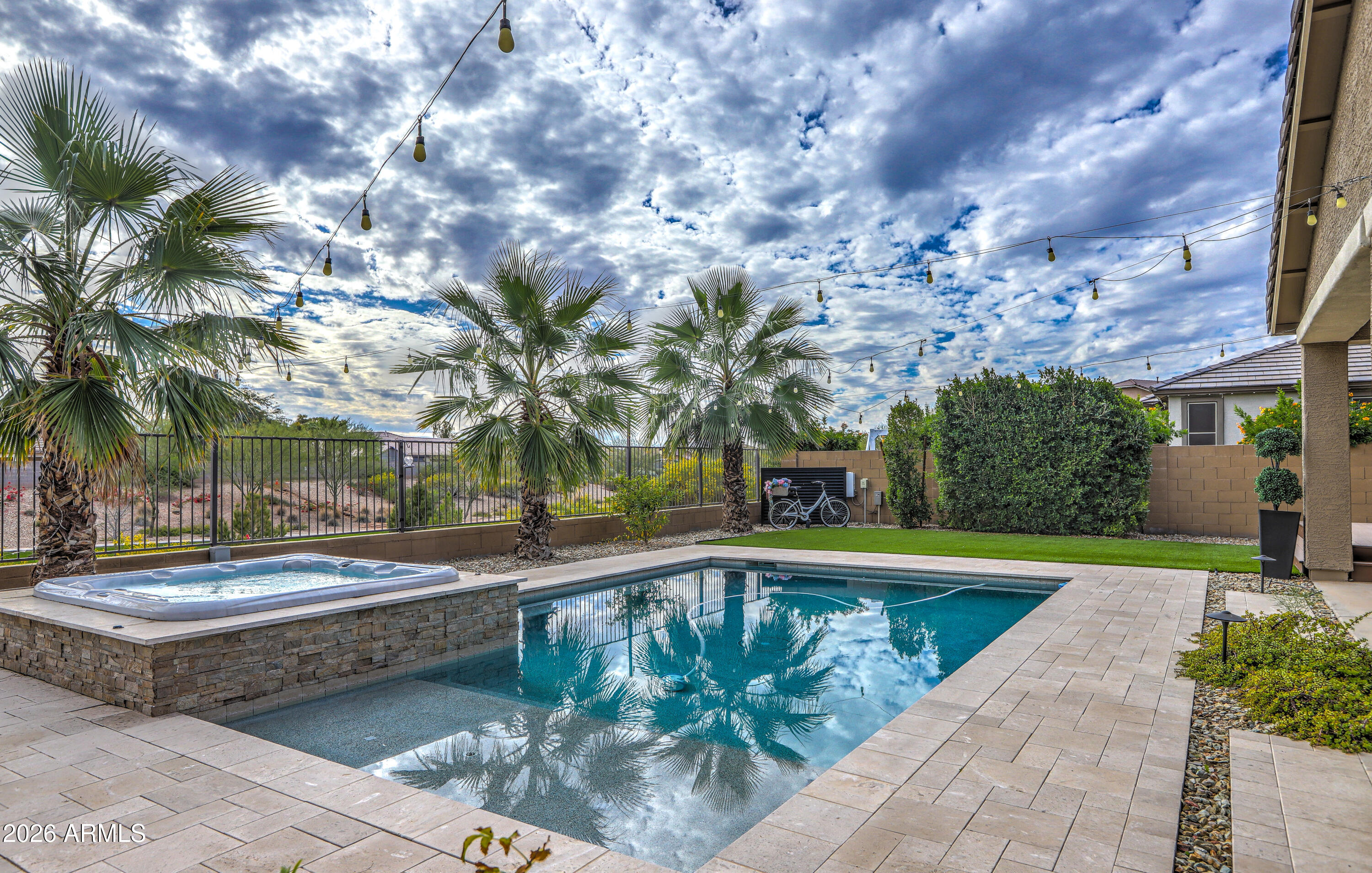 7727 West Agora Lane Phoenix, AZ 85043 - Photo 4 of 46 a view of swimming pool with outdoor seating and house in the background