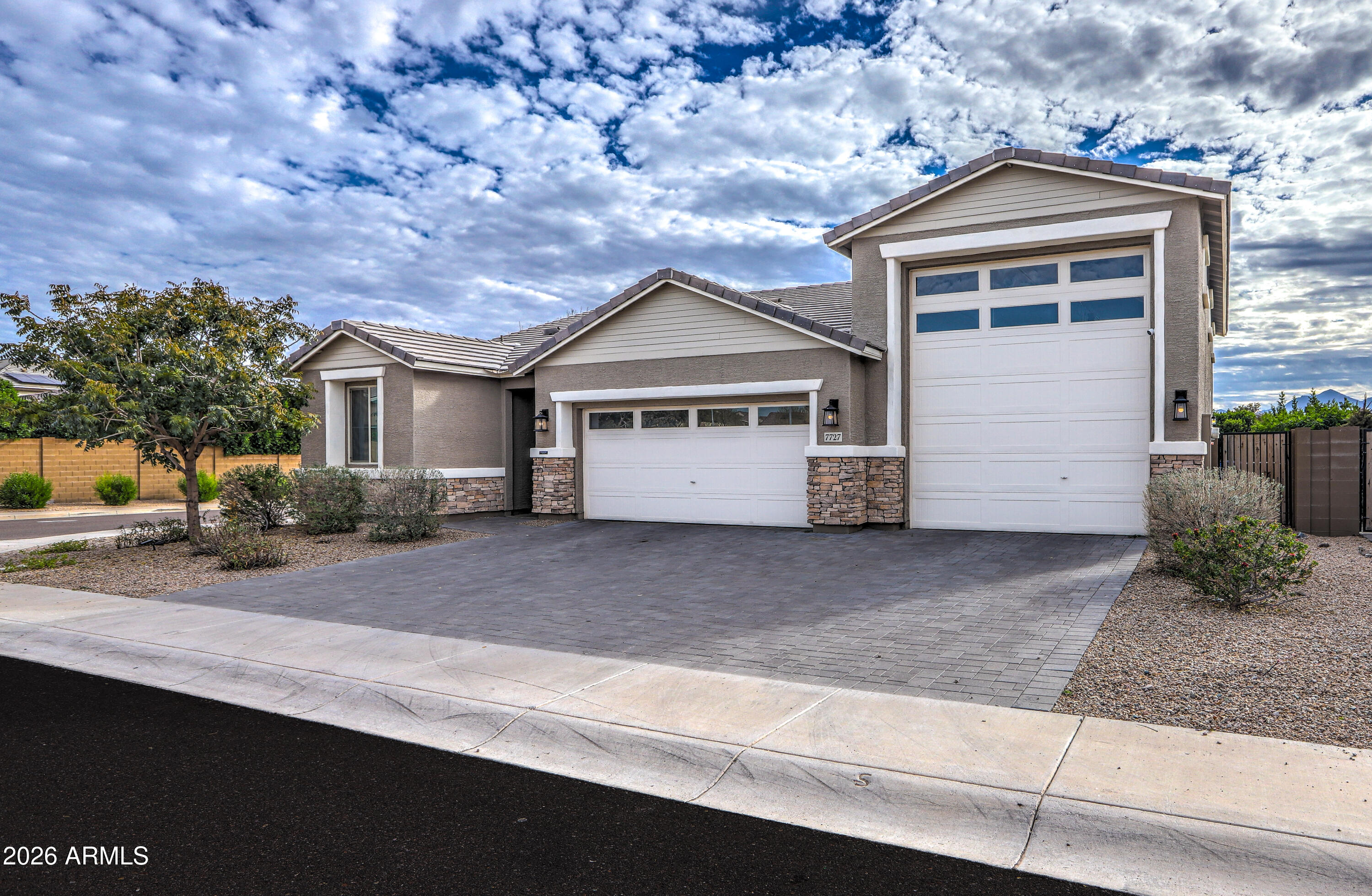 7727 West Agora Lane Phoenix, AZ 85043 - Photo 6 of 46 a front view of a house with a yard and garage