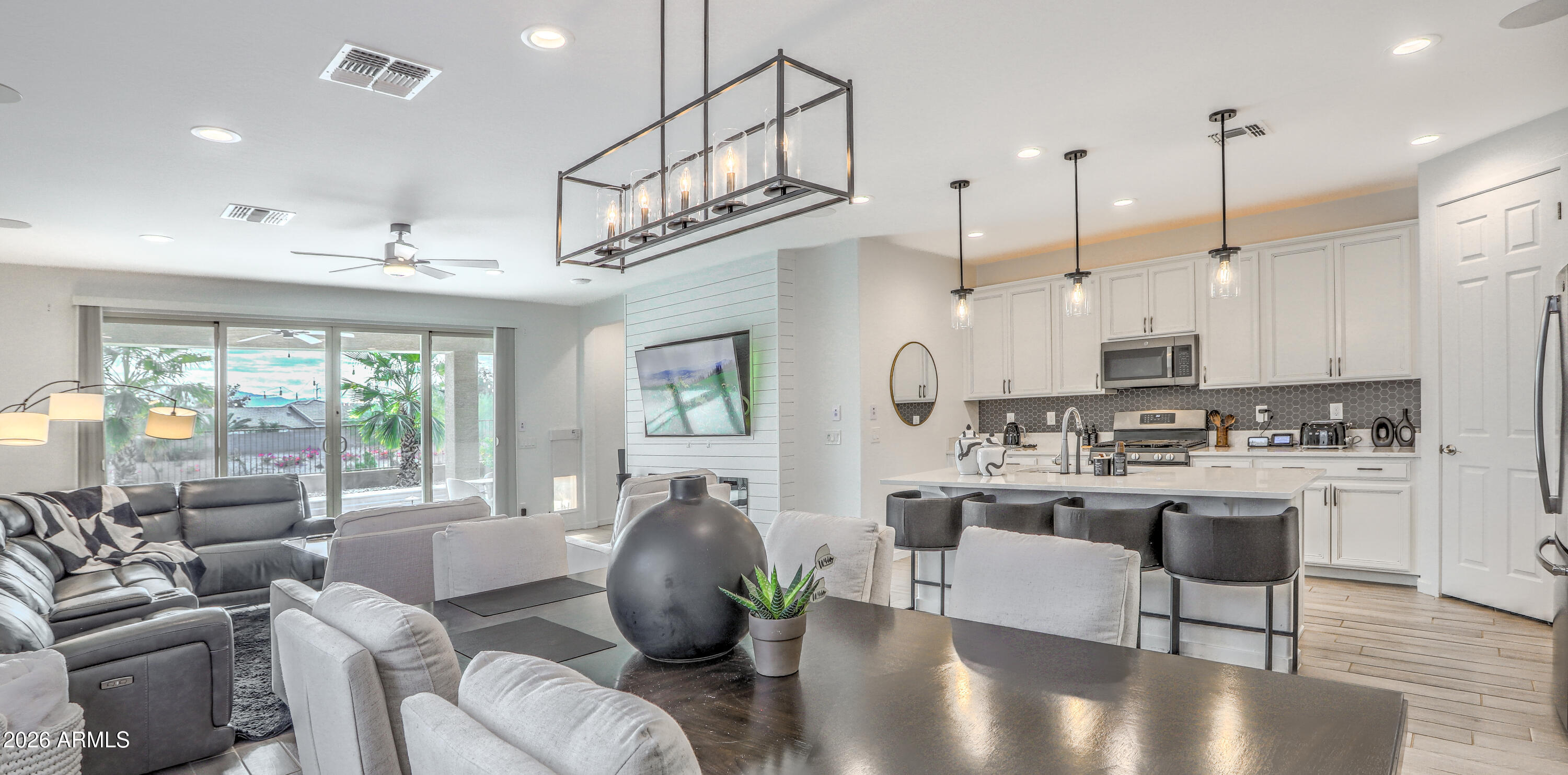 7727 West Agora Lane Phoenix, AZ 85043 - Photo 8 of 46 a living room with kitchen island furniture and a chandelier