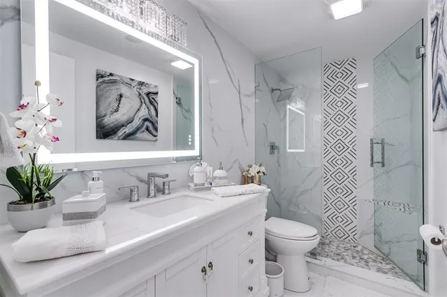 a bathroom with a sink toilet and shower