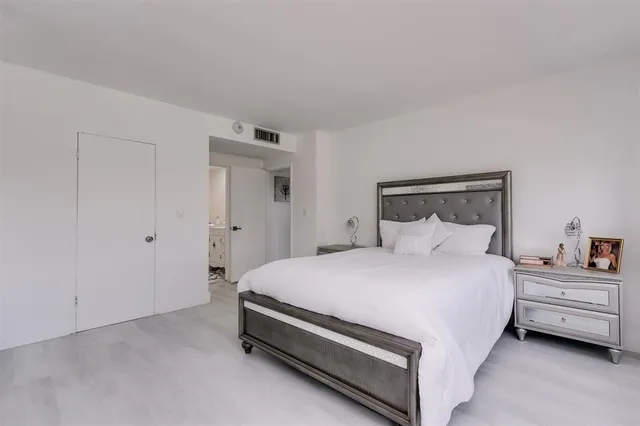 a bedroom with a bed and a lamp