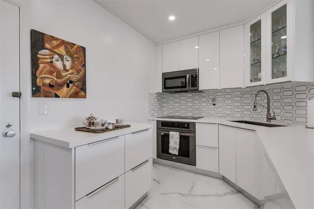 a kitchen with sink cabinets and microwave