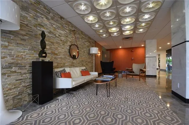 a lobby with furniture and a rug