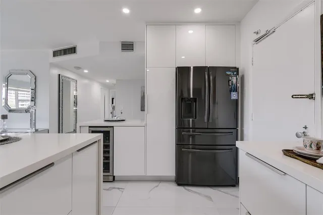 a kitchen with a refrigerator and a sink