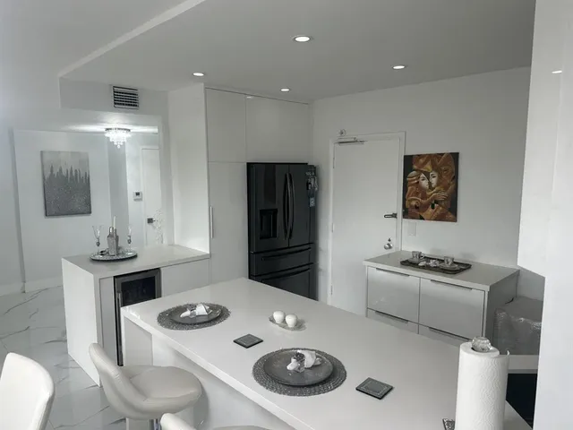 a kitchen that has a sink a stove and refrigerator