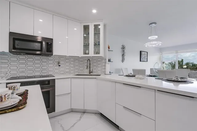 a kitchen with a sink stove and microwave