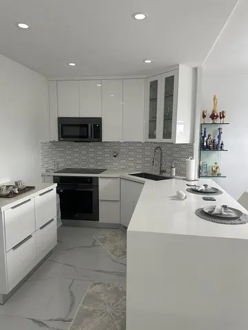a kitchen with a sink stove and microwave