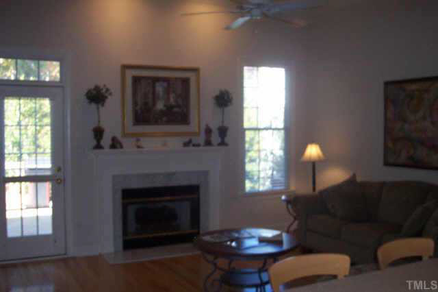 4212 Norman Ridge Lane Raleigh, NC 27613 - Photo 3 of 7 a living room with furniture a window and a fireplace