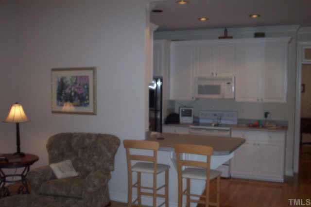 4212 Norman Ridge Lane Raleigh, NC 27613 - Photo 4 of 7 a kitchen with a table and chairs in it