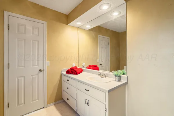 a bathroom with a sink vanity and a mirror