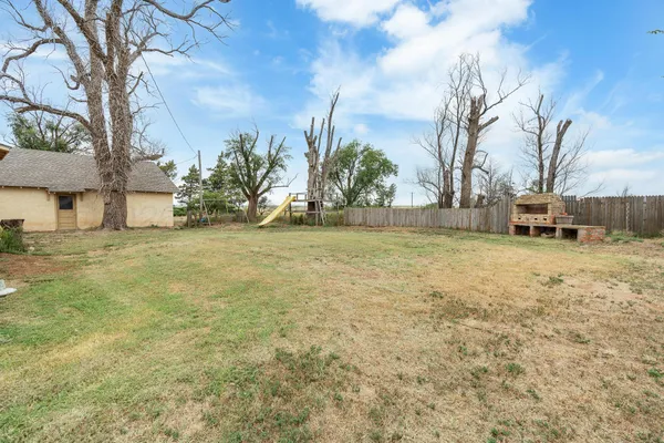 a view of a yard with a house in the background