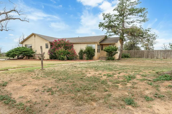 a view of a house with a yard and tree s