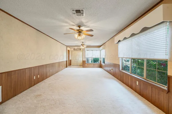 a view of a livingroom with a ceiling fan and window