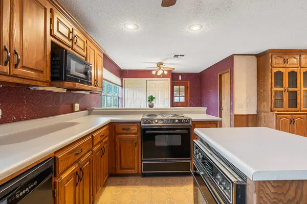 a kitchen with stainless steel appliances granite countertop a stove and a sink