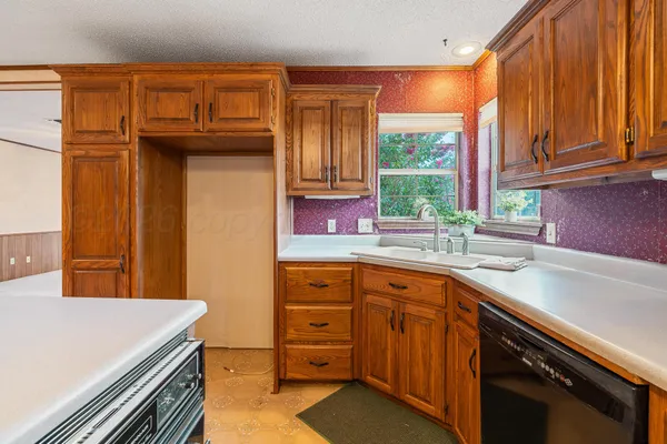 a kitchen that has a sink and a window in it
