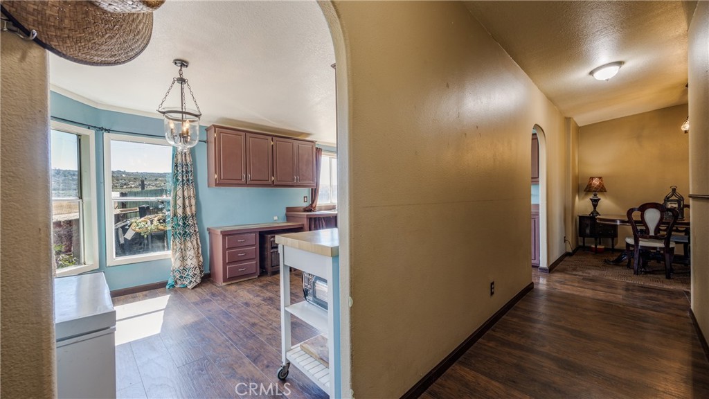39550 Kirby Road Anza, CA 92539 - Photo 8 of 53 a view of a hallway with wooden floor windows a chandelier and livingroom