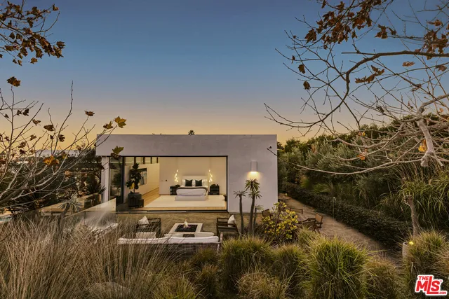 a view of swimming pool with outdoor seating and plants