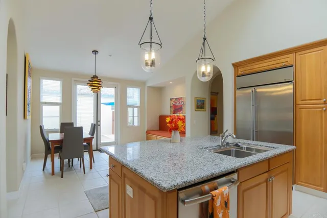 a kitchen with center island table and chairs