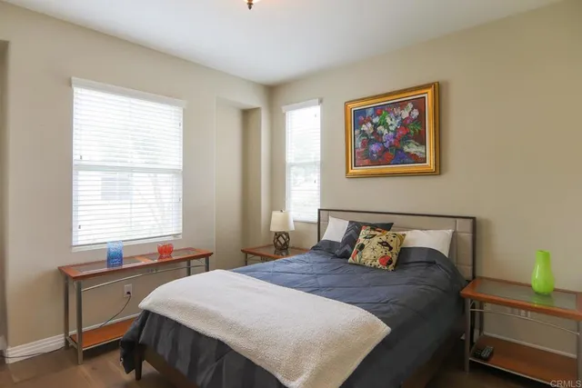 a bedroom with a bed and a window