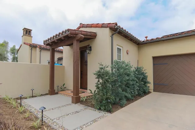 a view of a house with potted plants
