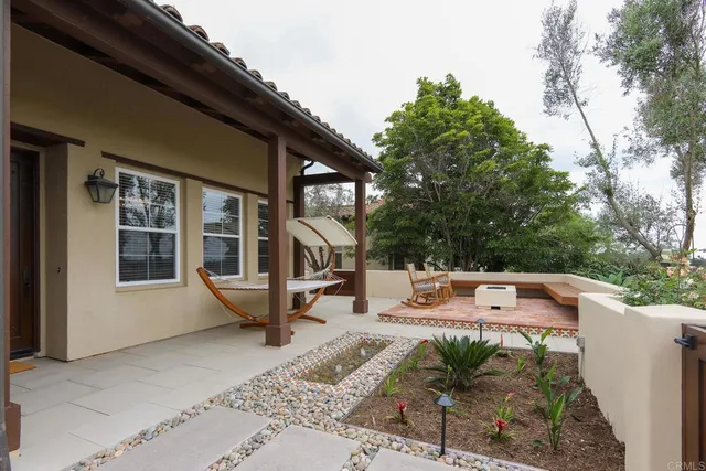 a view of a house with backyard sitting area and garden