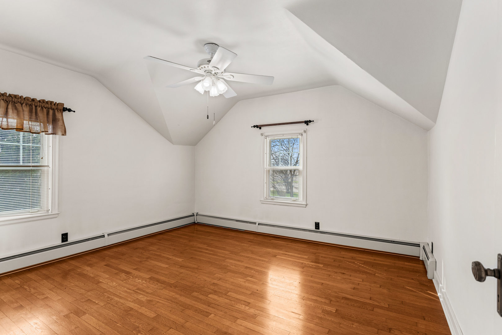 400 East 3rd Street Brocton, IL 61917 - Photo 24 of 54 an empty room with wooden floor chandelier fan and windows