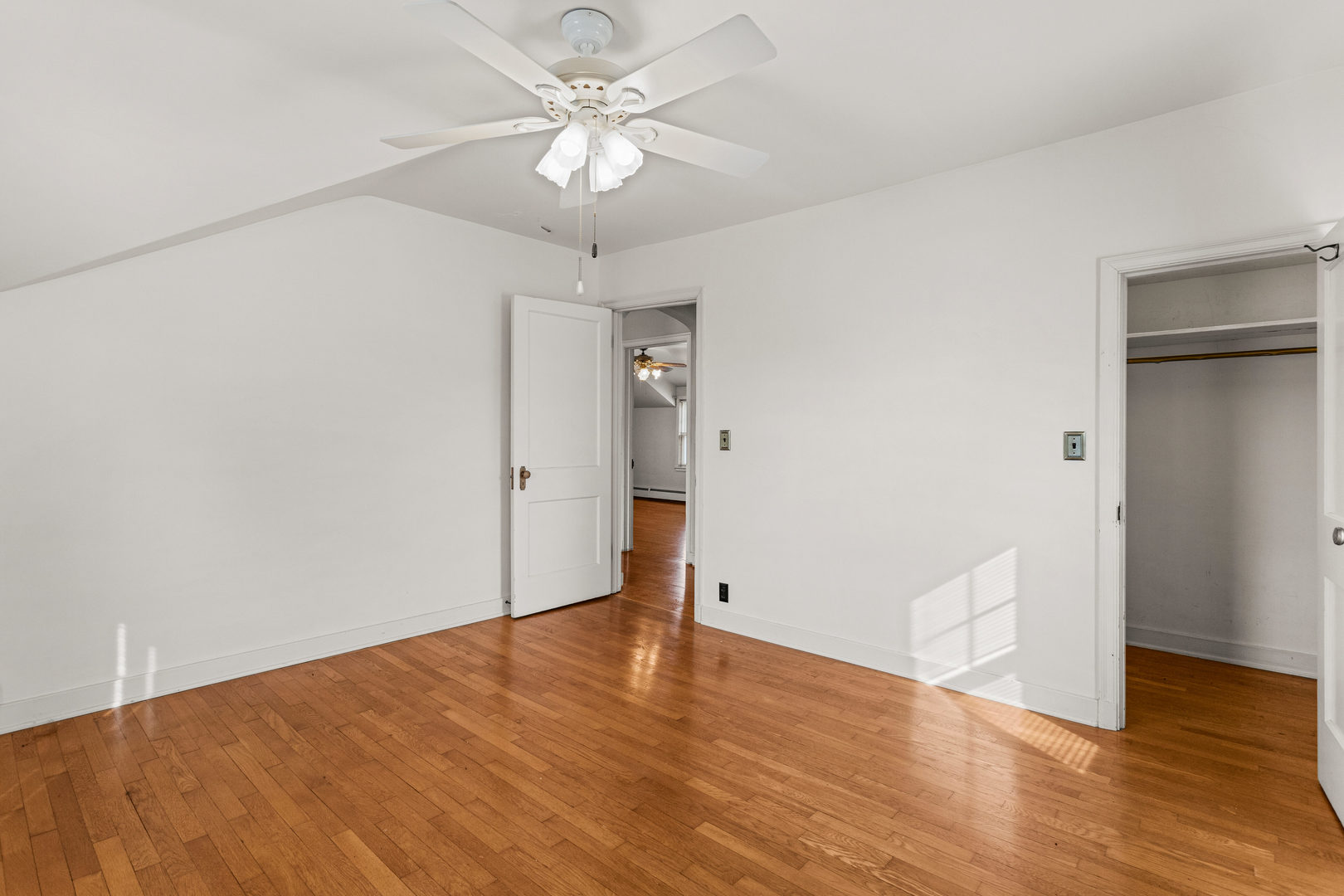400 East 3rd Street Brocton, IL 61917 - Photo 25 of 54 an empty room with wooden floor and ceiling fan