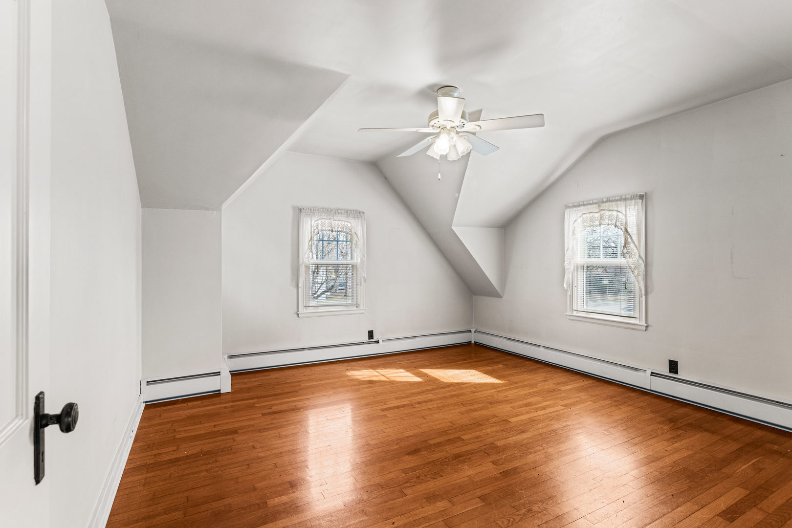 400 East 3rd Street Brocton, IL 61917 - Photo 26 of 54 an empty room with wooden floor chandelier fan and windows