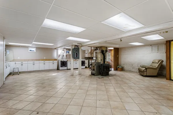 a view of a kitchen with fridge and wooden floor