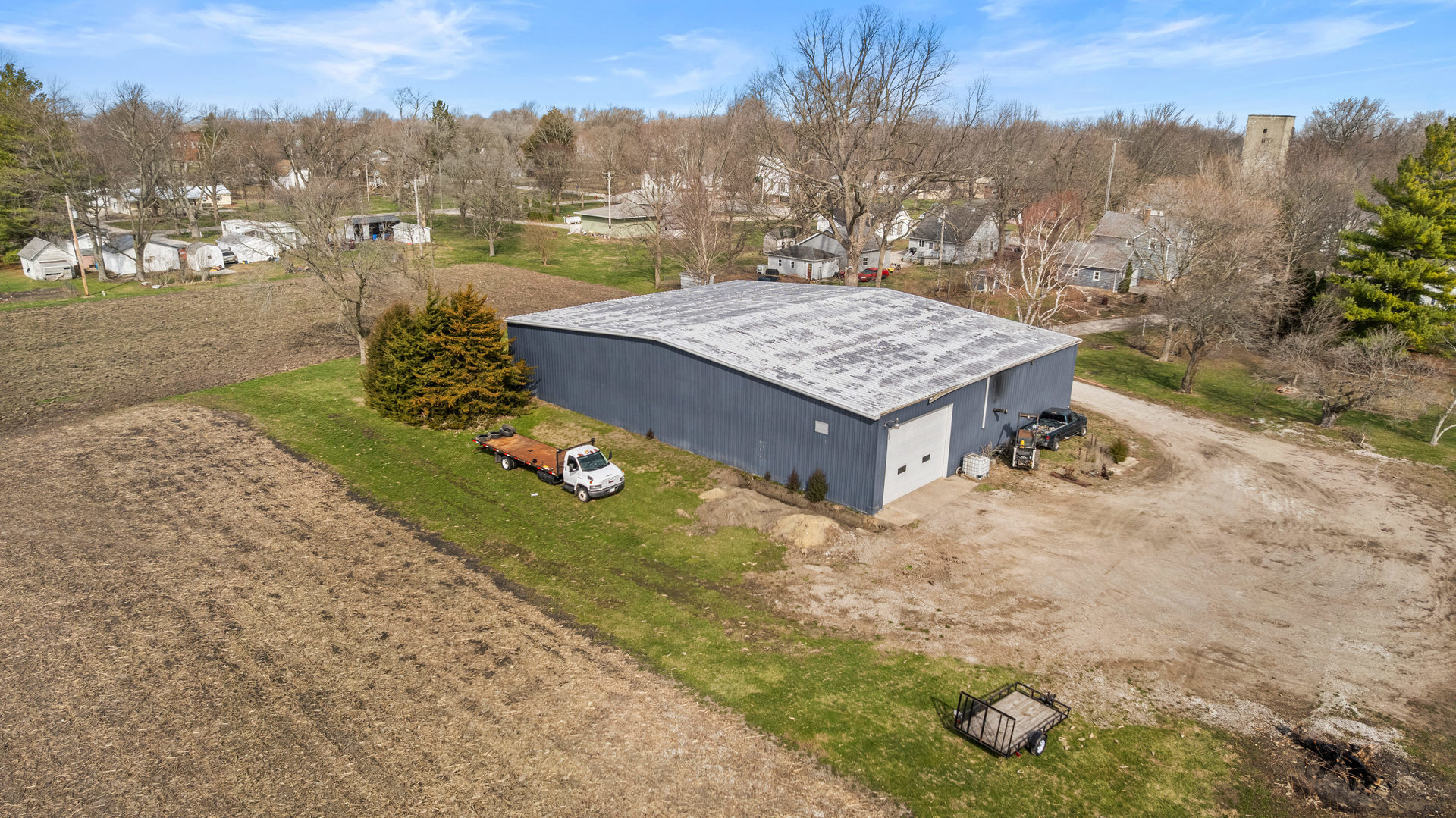 400 East 3rd Street Brocton, IL 61917 - Photo 44 of 54 an aerial view of a house with yard and trees in the background