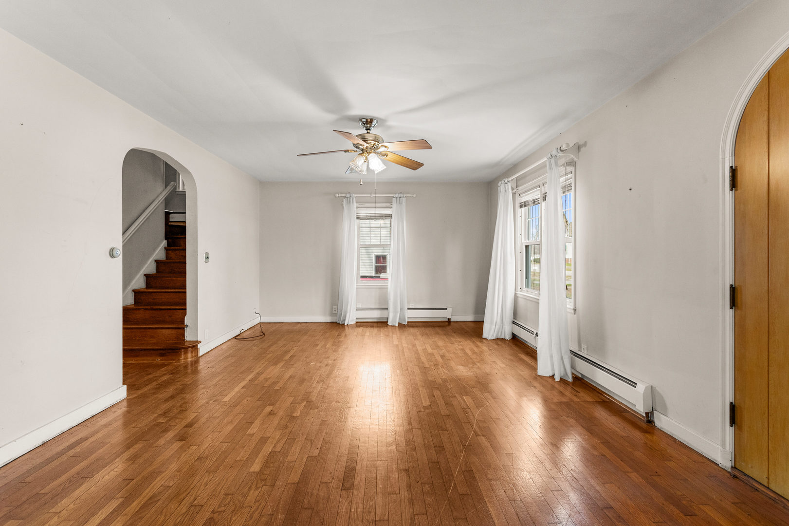 400 East 3rd Street Brocton, IL 61917 - Photo 9 of 54 an empty room with wooden floor and ceiling fan