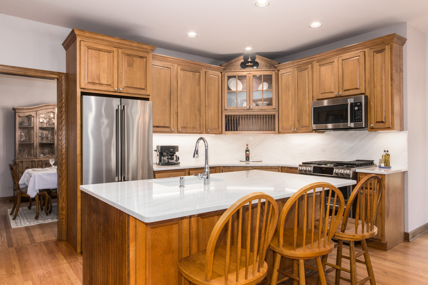 408 North Seminary Avenue Park Ridge, IL 60068 - Photo 12 of 26 a kitchen with granite countertop a stove top oven a sink a dining table and chairs