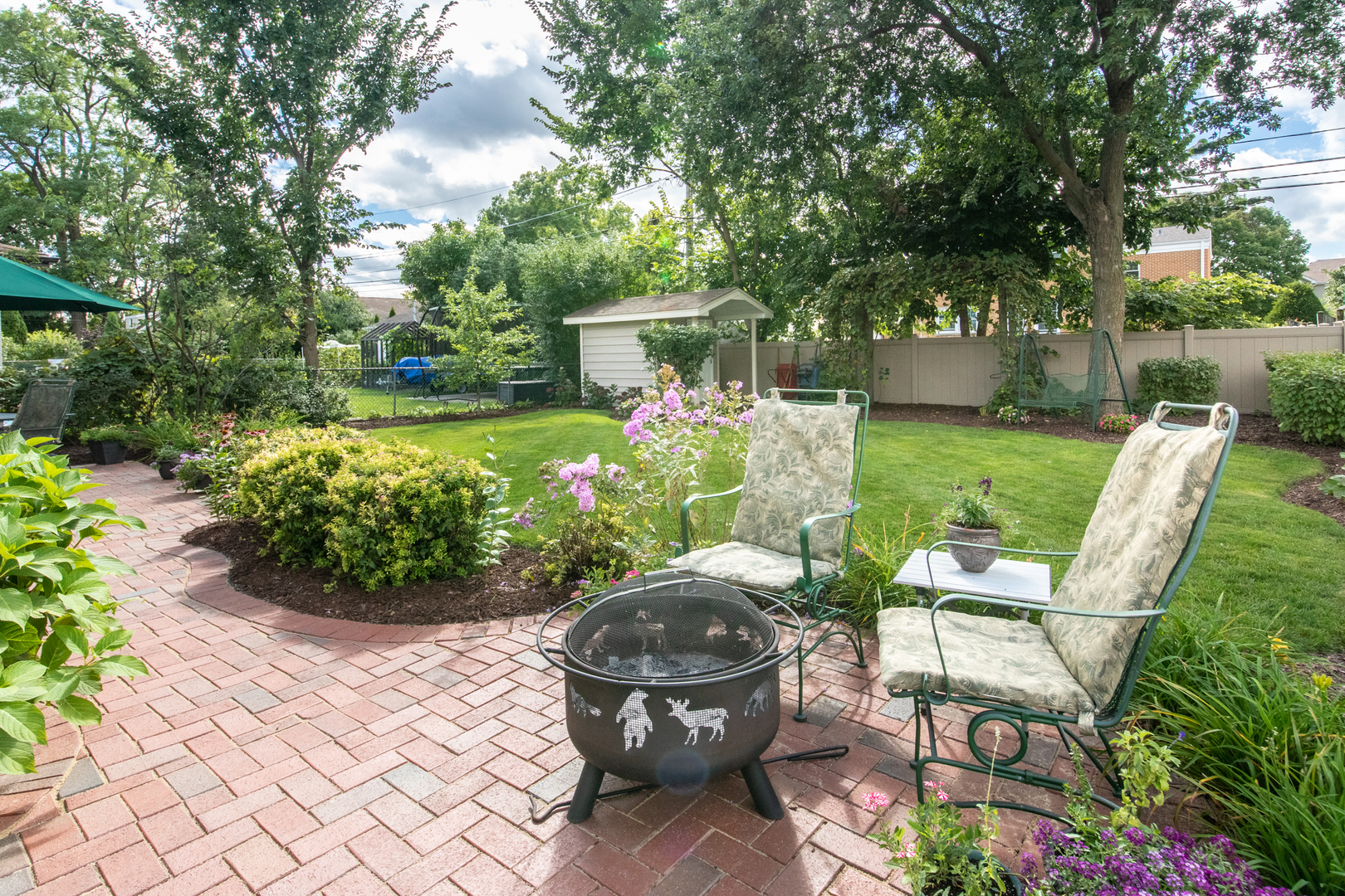 408 North Seminary Avenue Park Ridge, IL 60068 - Photo 24 of 26 a view of a chair and table in backyard with potted plants and large trees