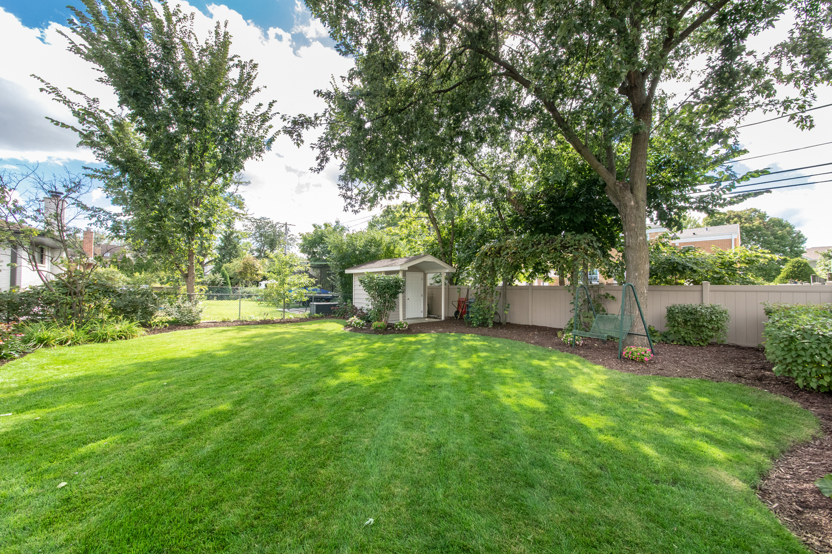 408 North Seminary Avenue Park Ridge, IL 60068 - Photo 26 of 26 a backyard of a house with plants and large trees