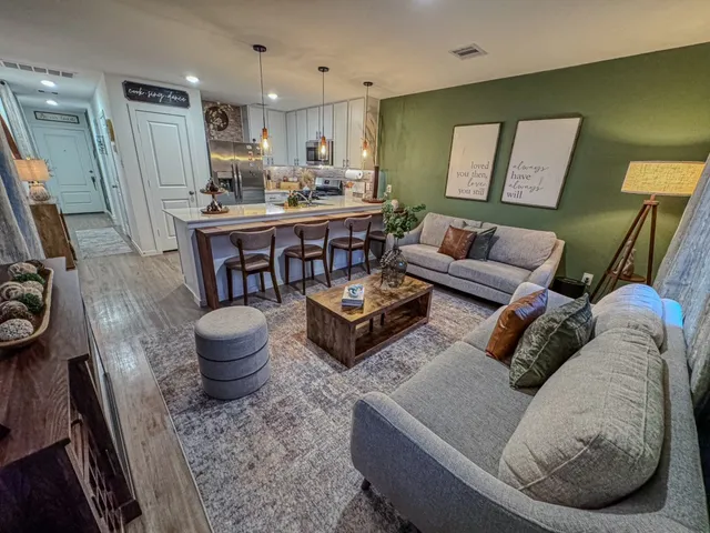 a living room with furniture and a mirror