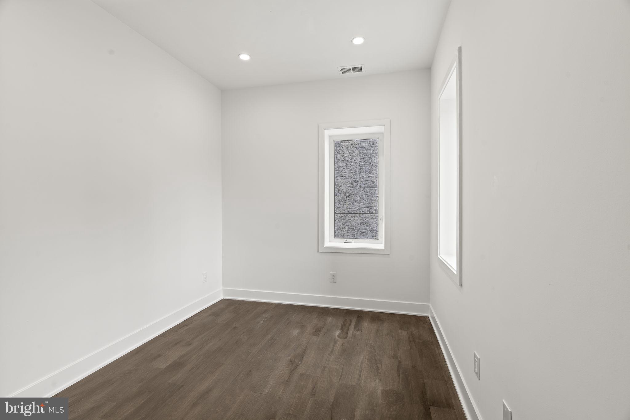 1244 South 20th Street, Unit 2 Philadelphia, PA 19146 - Photo 12 of 30 an empty room with wooden floor and windows