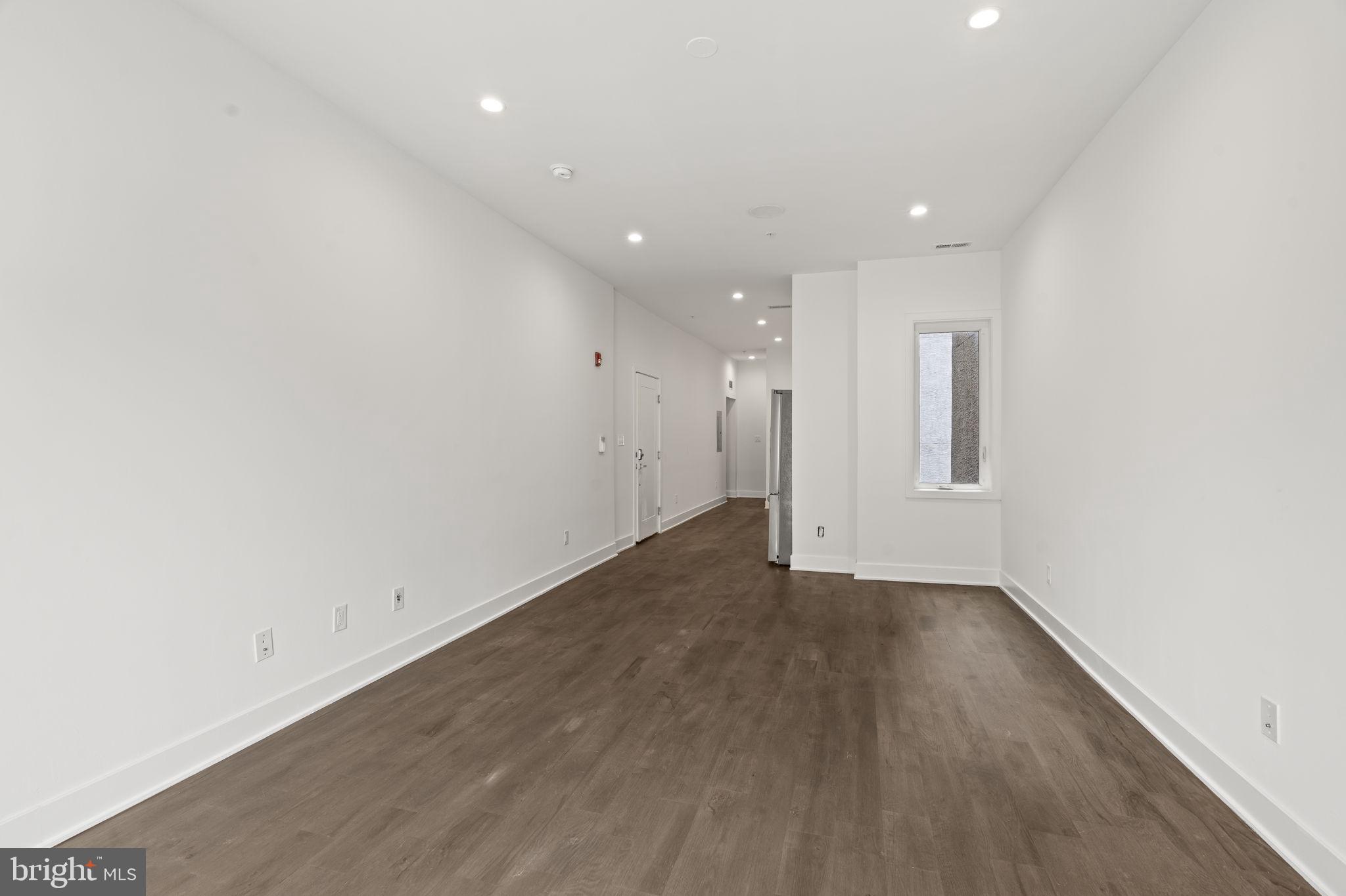 1244 South 20th Street, Unit 2 Philadelphia, PA 19146 - Photo 7 of 30 an empty room with wooden floor and windows