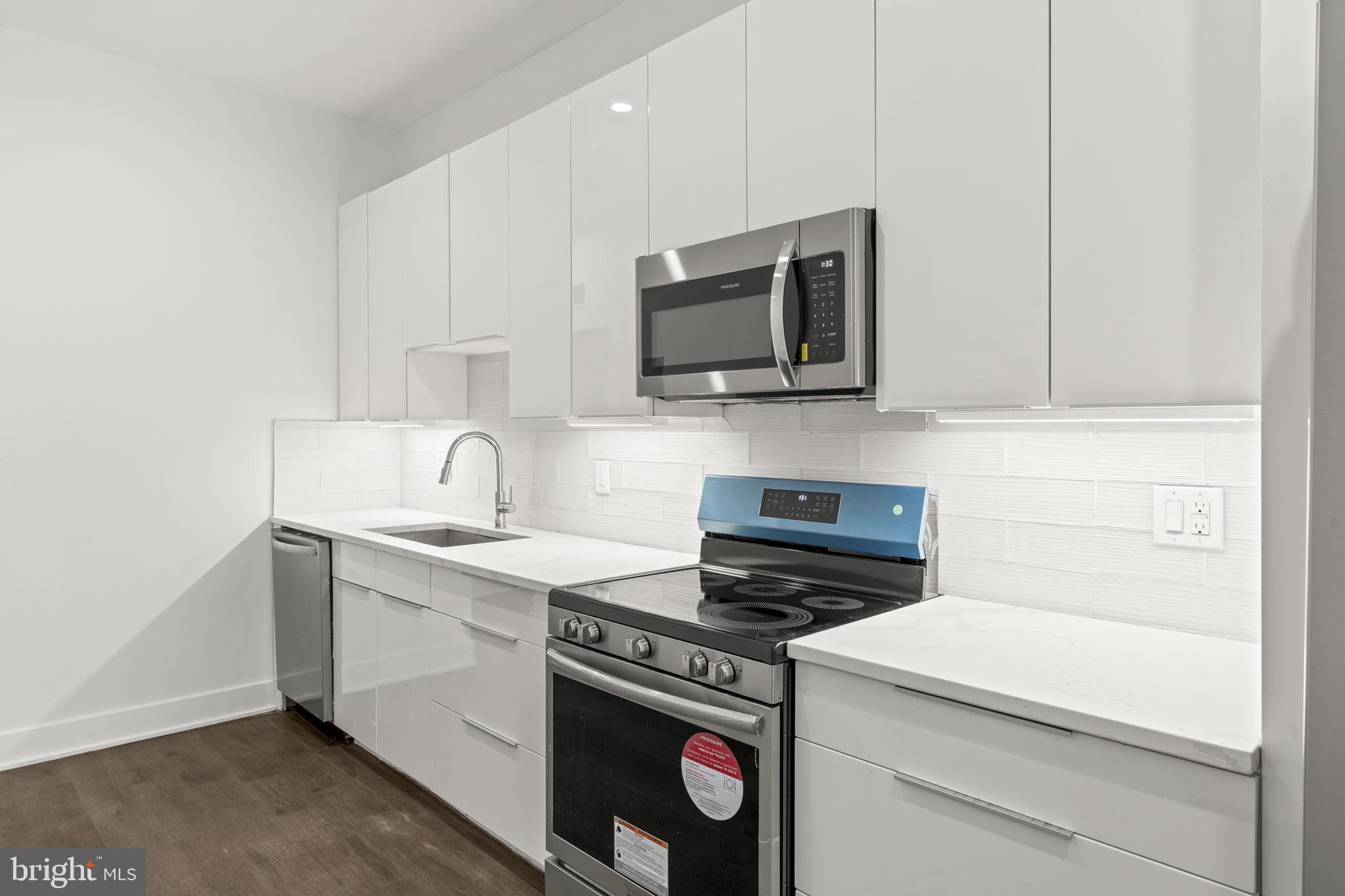 1244 South 20th Street, Unit 2 Philadelphia, PA 19146 - Photo 10 of 30 a kitchen with a sink stove and microwave