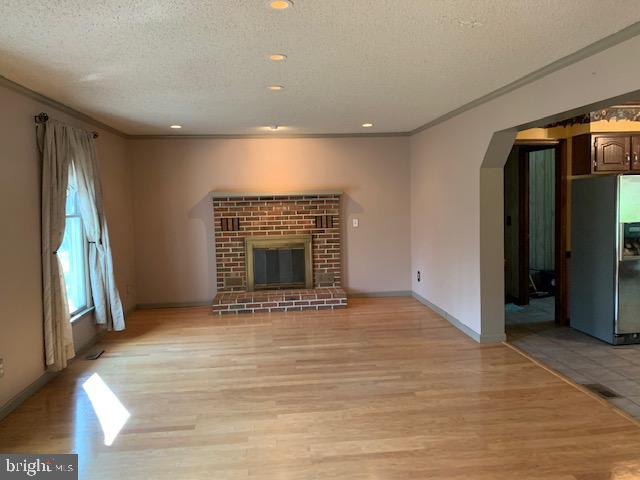 120 Lums Pond Road Bear, DE 19701 - Photo 5 of 28 Large living room w. wood burning brick fireplace.